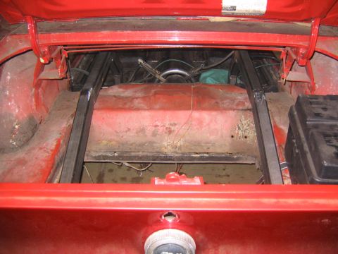 1969 Ford Mustang - The trunk of a 1969 Ford Mustang shows custom metal bracing and a fuel cell, indicating modifications.