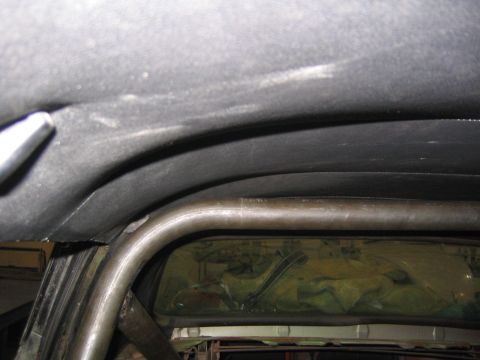1969 Ford Mustang - View of a car's interior, focusing on the headliner and a metal roll cage structure.