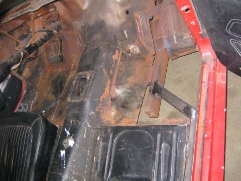 1969 Ford Mustang - Interior view of a 1969 Ford Mustang, highlighting rust damage on the floor pan.