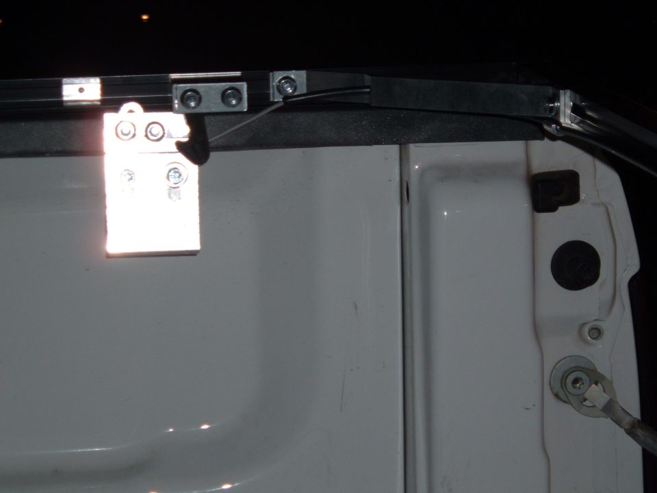 Close-up of tonneau cover mounting hardware on a truck bed
