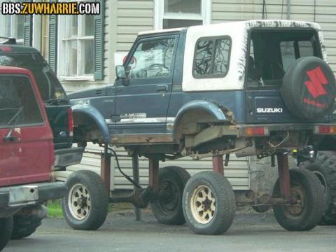 1979 Ford Bronco - This heavily modified Suzuki Samurai features a custom chassis with multiple axles, giving it an extreme lifted appearance.