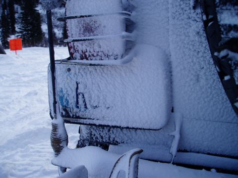 2000 Ford E350 - Vehicle rear corner covered in snow with a partial license plate visible.