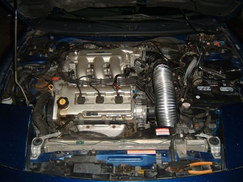 1994 Ford Probe - Engine bay of a 1994 Ford Probe, showing the V6 engine and associated components.