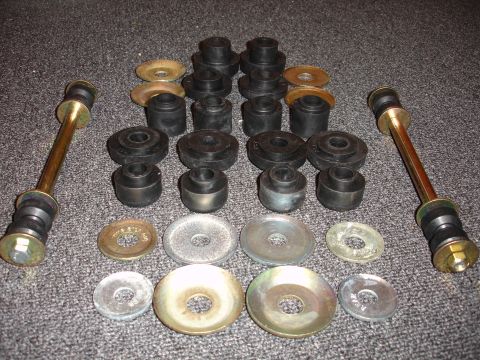 1993 Ford Taurus - Various suspension bushings and washers are laid out on a textured gray surface.