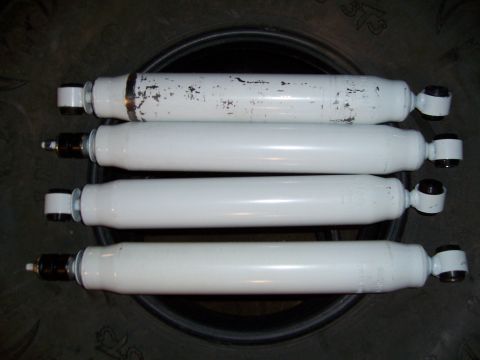 1983 Ford Bronco - Four white shock absorbers are shown, with one having some paint chipping.