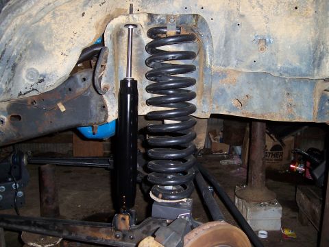 1983 Ford Bronco - The image shows the suspension system of a vehicle, focusing on the coil spring and shock absorber.