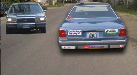1988 Ford LTD Crown Victoria - Two sedans are parked on pavement, one in the foreground and another further back.