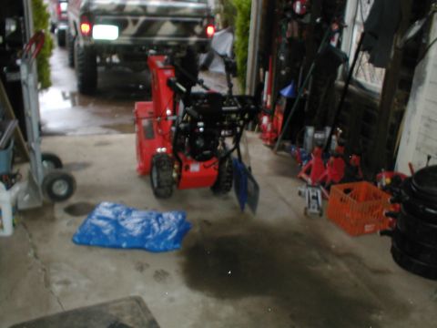 1979 Ford Bronco - A camouflage pickup truck is parked in a garage with a snowblower in the foreground.