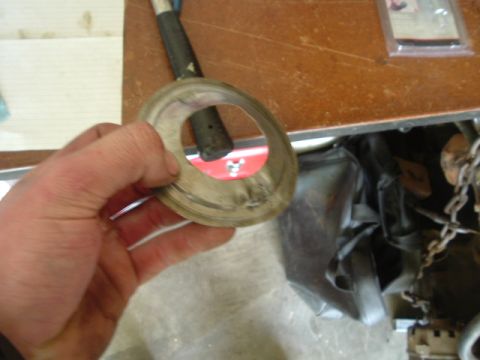 1989 Ford Bronco - Close-up of a metal ring being held, with a tool handle visible through its opening.