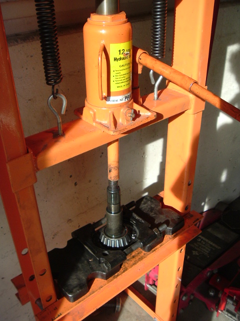 1989 Ford Bronco - A hydraulic press is used to work on a differential gear and pinion, likely for a regear or rebuild project.