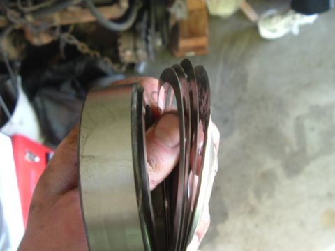 1989 Ford Bronco - Stack of shims held in hand, likely for a D60 regear or rebuild project.