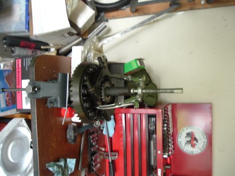 1989 Ford Bronco - A differential gear assembly is being worked on in a garage setting, with tools and a toolbox visible.