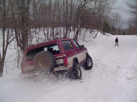 1995 Ford Bronco - This 1995 Ford Bronco navigates a snowy incline, kicking up snow as it goes.