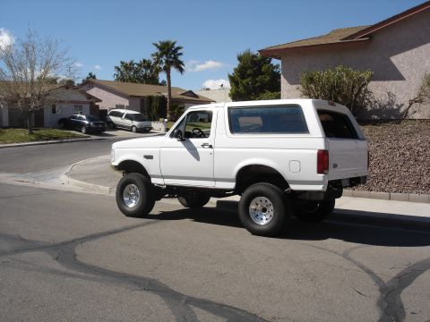1996 Ford Bronco - This lifted 1996 Ford Bronco features aftermarket wheels and a raised suspension, giving it a commanding presence on the road.