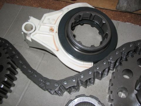 1995 Ford Bronco - Close-up of automotive transfer case components, including a chain and gears.