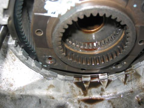 1995 Ford Bronco - Internal view of a vehicle's transfer case, showing gears and signs of fluid leakage.