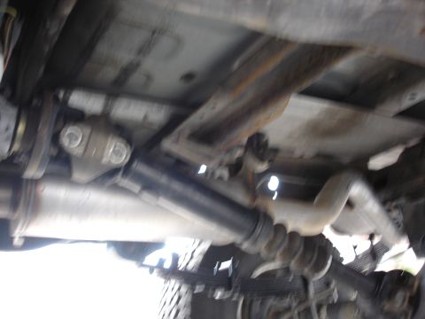 1996 Ford Bronco - The underbody of a vehicle shows the exhaust system and driveshaft, with a SuperMotors watermark visible.