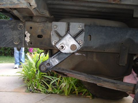 1989 Ford Bronco - A custom bracket is bolted to the vehicle's frame, connecting to the rear suspension components.