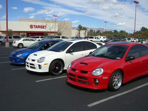 1996 Ford Probe - Three Dodge Neon SRT-4s are parked in a lot outside a Target store on a sunny day.