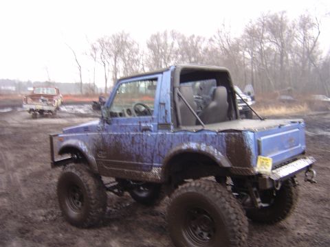 1987 Suzuki Samurai - This lifted 1987 Suzuki Samurai is covered in mud after an off-road excursion.