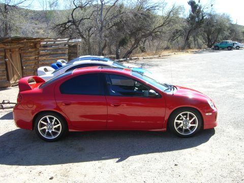 1996 Ford Probe - Side view of a red Dodge Neon SRT-4 with aftermarket wheels and a spoiler.