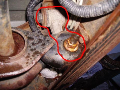 2000 Chevrolet Tahoe - Close-up view of corroded vehicle suspension components and wiring harness.
