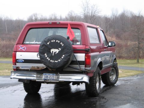 1995 Ford Bronco - The rear view of a red Ford Bronco shows its spare tire and license plate.
