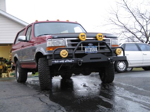 1995 Ford Bronco - This modified Ford Bronco features a custom bull bar and decorative smiley face lights.