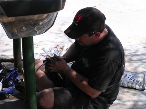 1988 Ford Bronco - Mechanic performs work on a vehicle component, possibly during an installation.
