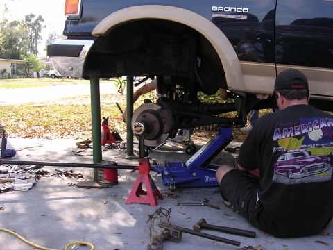 1988 Ford Bronco - A 1988 Ford Bronco is shown from the side while undergoing a lift installation.