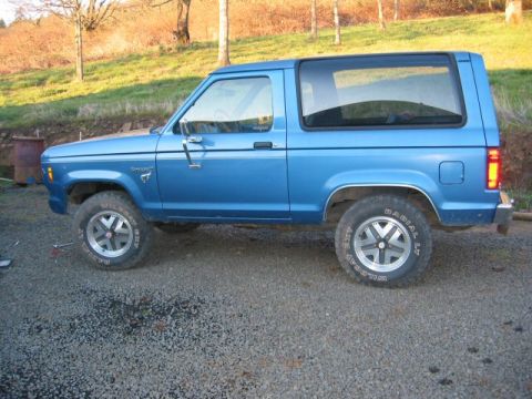 1991 Ford Explorer - Blue 1989 Ford Bronco II shown from the side.
