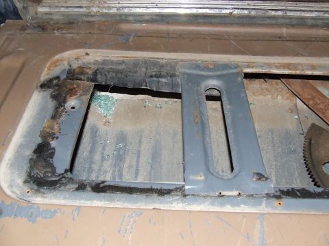 1986 Ford Bronco - The frame around the rear window shows significant rust and damage, with remnants of broken glass.