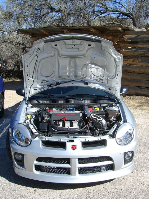 1996 Ford Probe - Silver Dodge Neon SRT-4 with hood open, revealing the engine bay and SRT-4 badging.