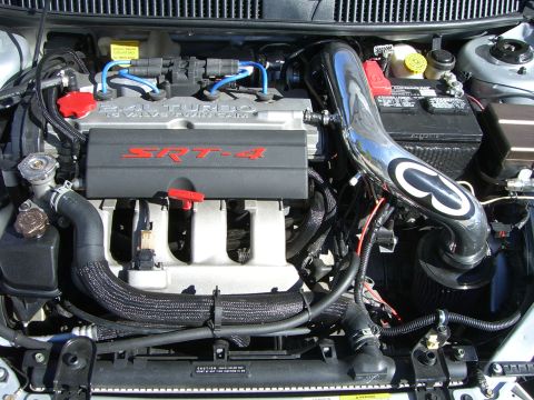 1996 Ford Probe - Close-up view of an engine bay SRT-4 badging on the valve cover and a polished chrome intake system.