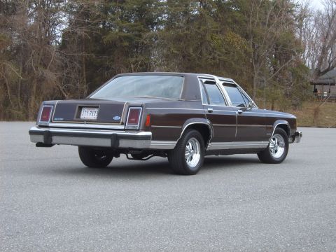 1982 Ford Crown Victoria LTD - This brown sedan has a boxy body style and chrome wheels, typical of early 1980s models.