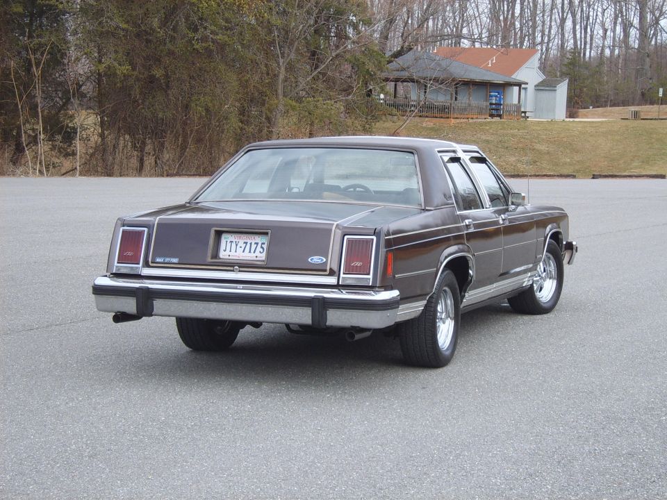 Brown Ford LTD sedan rear three-quarter view with dual exhaust and Virginia plate
