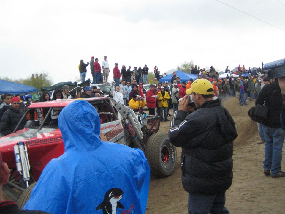 Red number 4 off-road buggy with BFGoodrich decal among spectators