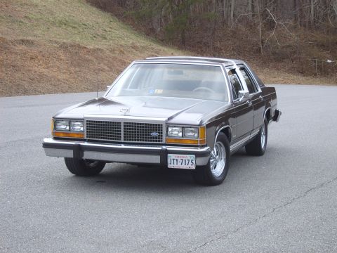 1982 Ford Crown Victoria LTD - A gray Ford Crown Victoria with aftermarket Cragar SS wheels is shown from a three-quarter front view.