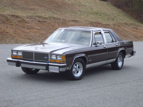 1982 Ford Crown Victoria LTD - This dark brown sedan, likely from the early 1980s, is shown from a three-quarter front angle.