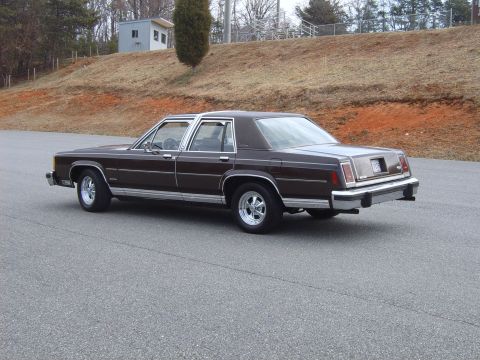 1982 Ford Crown Victoria LTD - Rear three-quarter view of a brown sedan with chrome trim and Cragar SS wheels.