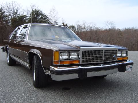 1982 Ford Crown Victoria LTD - A brown 1980 Ford LTD Crown Victoria is shown from the front three-quarter view, aftermarket Cragar SS wheels.