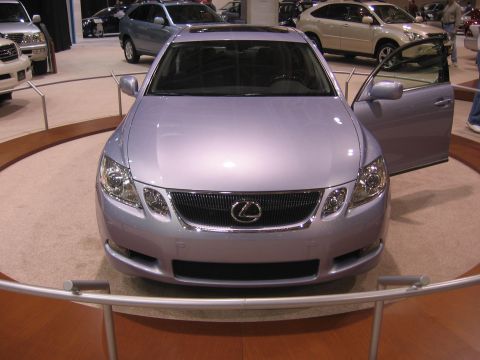 1999 Ford Crown Victoria - Silver Lexus GS sedan displayed at an auto show with its driver door open.