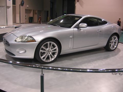 1999 Ford Crown Victoria - A silver coupe is displayed indoors, with a watermark for Supermotors.net visible at the bottom right.