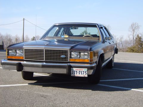 1982 Ford Crown Victoria LTD - This sedan features a prominent chrome grille and a classic boxy body style, indicative of the early 1980s.