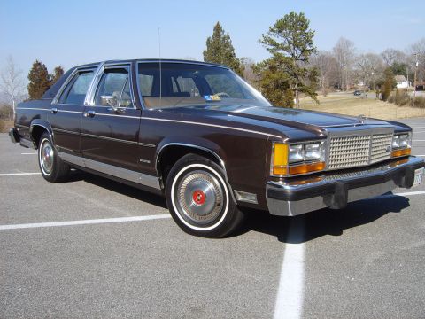 1982 Ford Crown Victoria LTD - This 1983 Ford LTD Crown Victoria is parked in a lot with trees in the background.