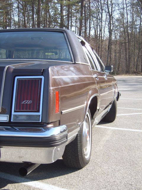 1982 Ford Crown Victoria LTD - Rear quarter view of a brown 1982 Ford Crown Victoria LTD, showing its distinctive taillight and chrome accents.