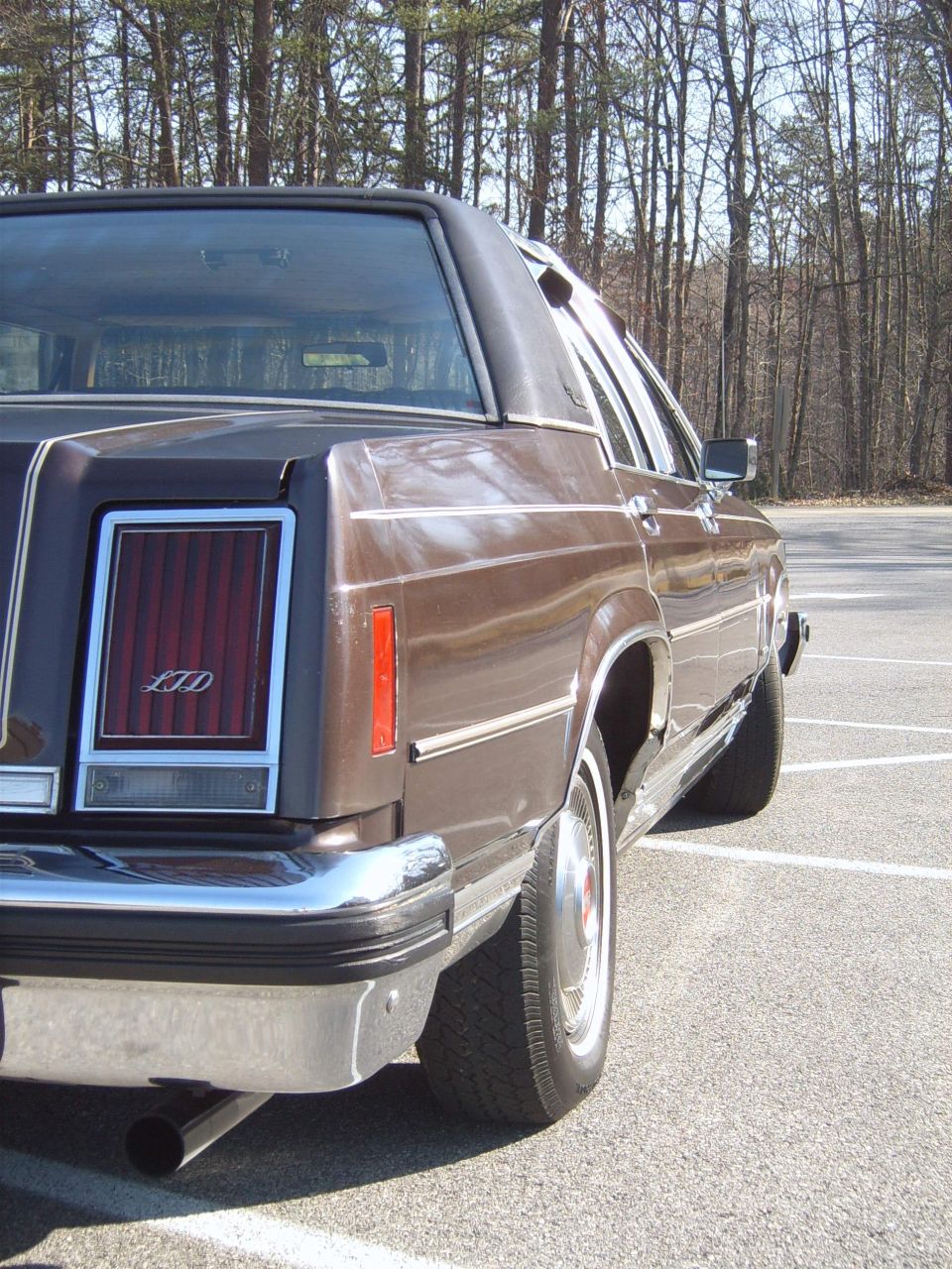 Brown 1982 Ford Crown Victoria LTD rear quarter view with chrome bumper and LTD badging
