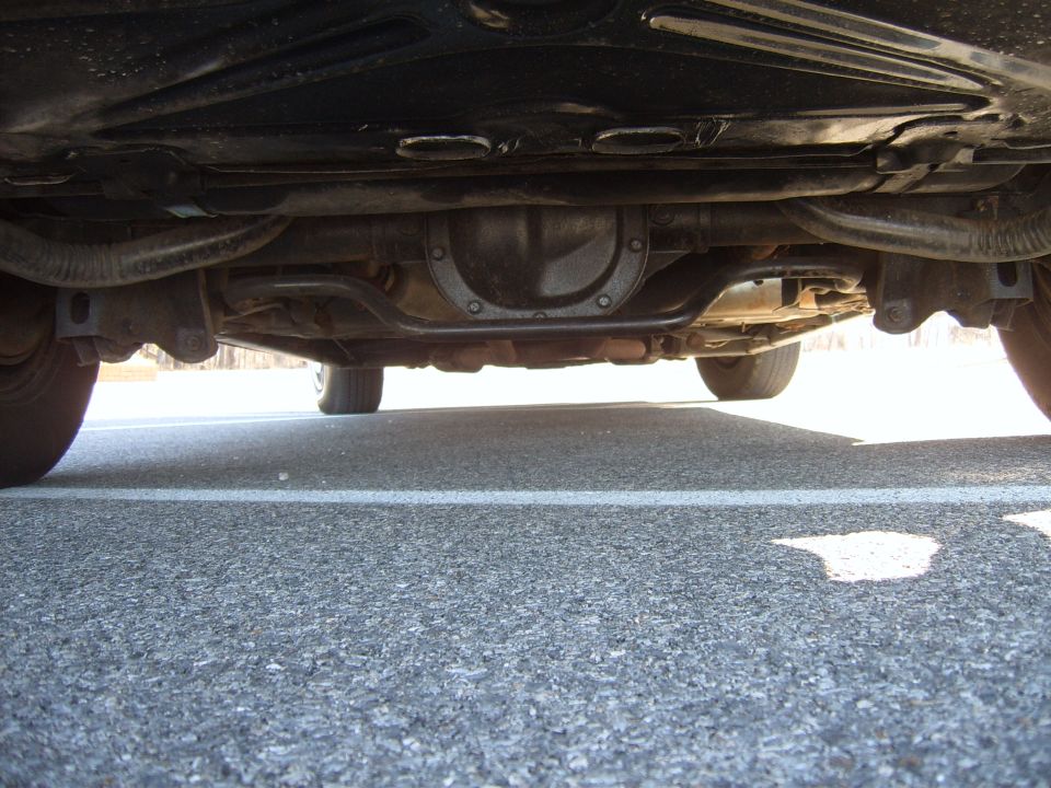 Underside view of a car's rear differential and suspension components