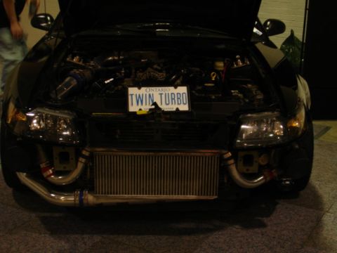 1981 Ford Mustang - This modified black car displays its twin turbo engine setup with an Ontario license plate.
