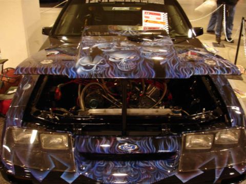 1981 Ford Mustang - This 1981 Ford Mustang features a striking custom airbrushed design with skulls and flames on the hood and front end.
